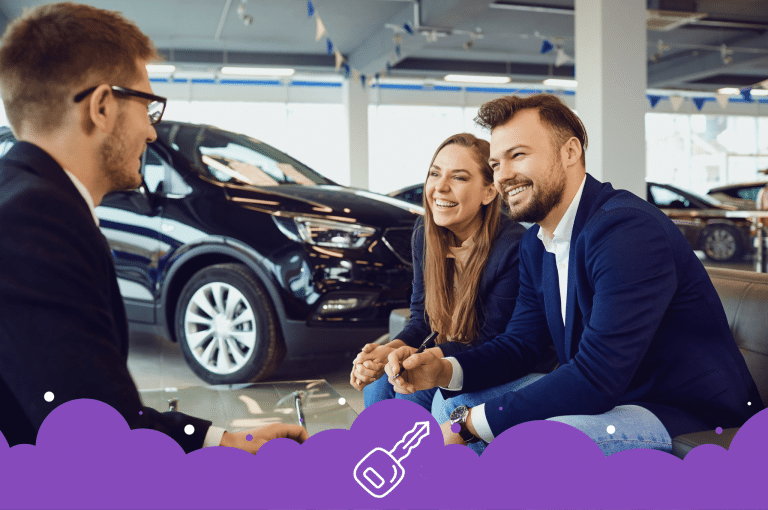 Photo of a couple buying a new car at a dealership in Edmonton