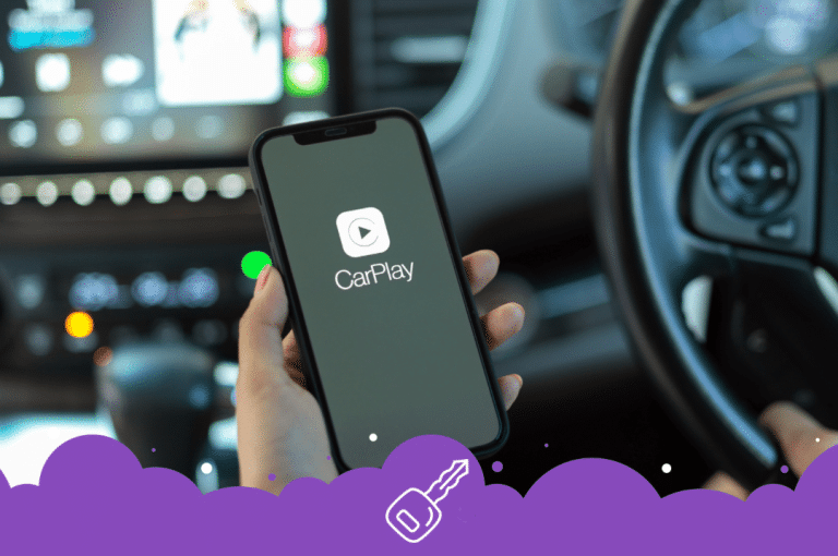 a hand holding a phone in front of a car