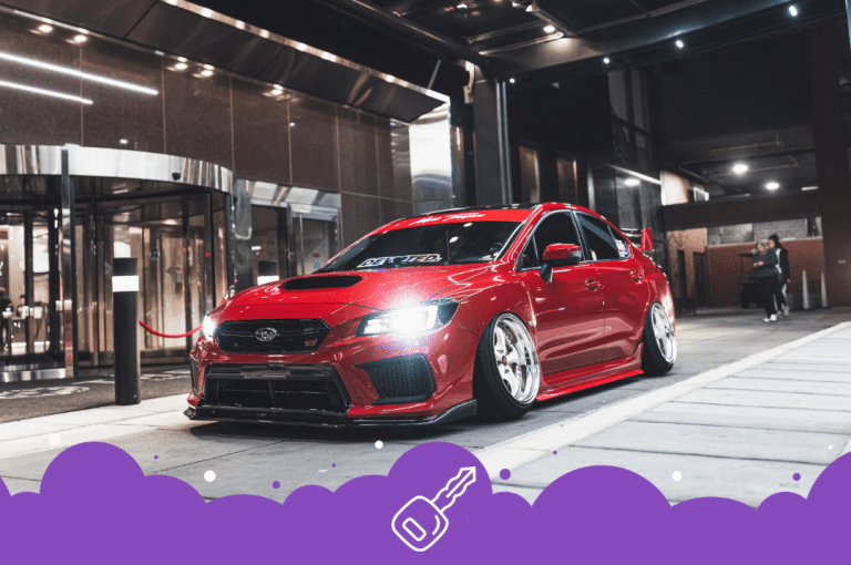 a red car parked outside a building