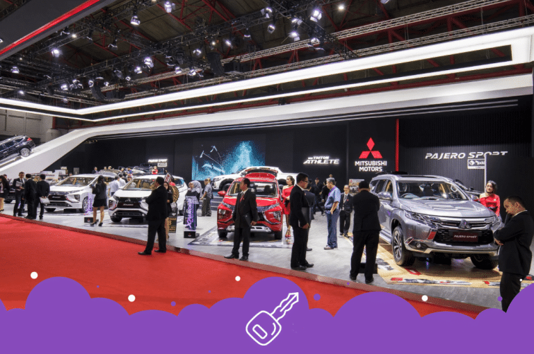 a group of people standing in a room with cars
