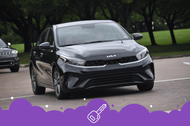Black Kia forte driving on the road