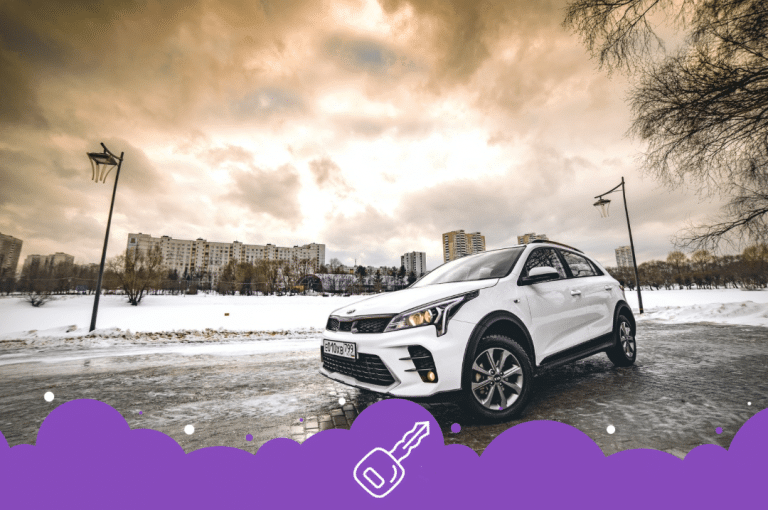 White Kia rio in a parking lot