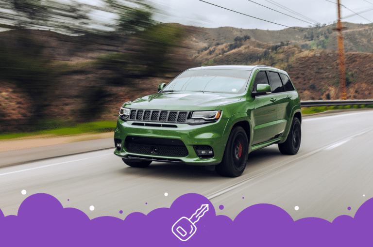 Green jeep grand Cherokee driving down the road