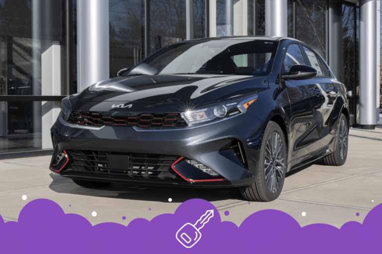 Grey Kia forte parked infront of the dealership