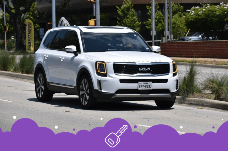 White Kia Telluride driving on the road