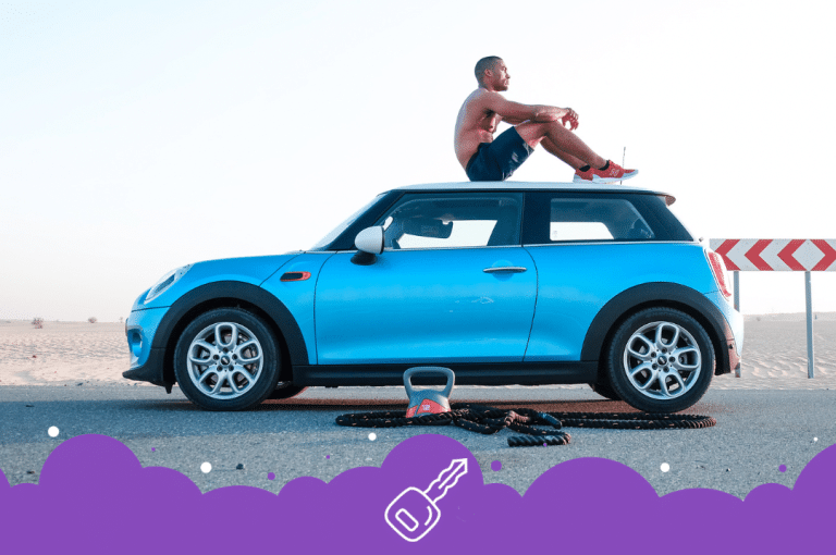 a man sitting on top of a car