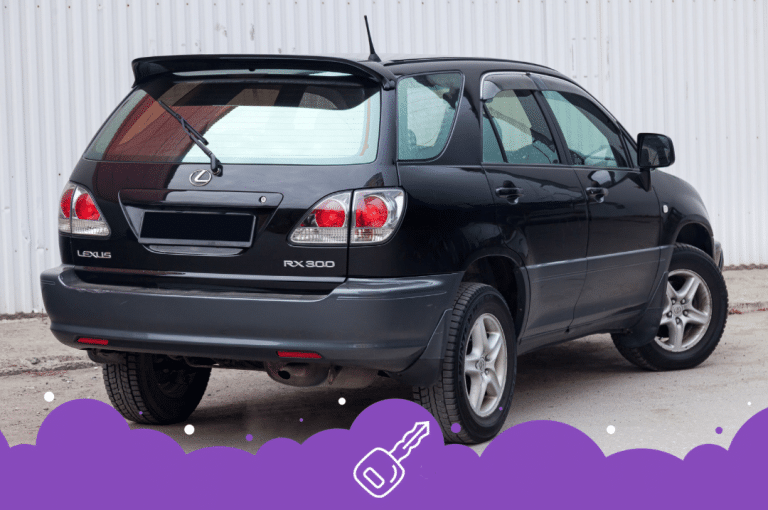 a black car parked in front of a white wall