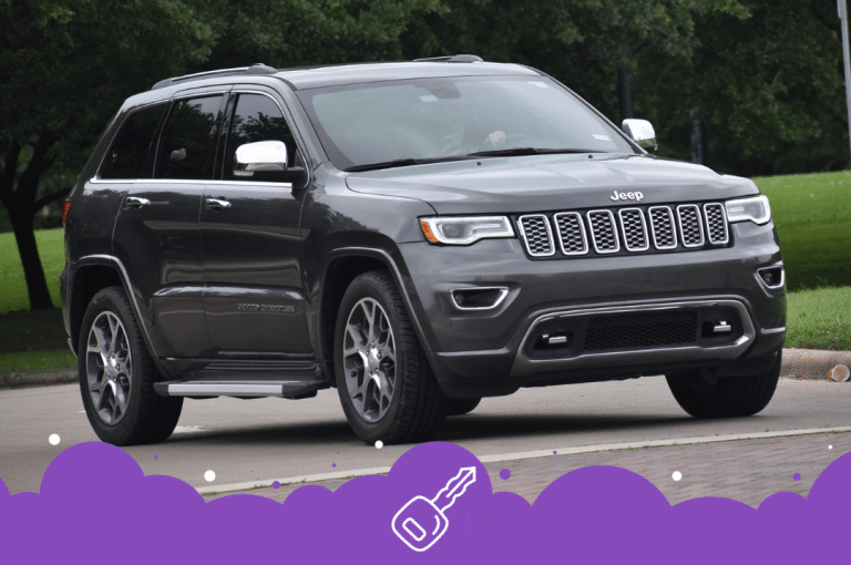 Grey jeep grand Cherokee driving on the road