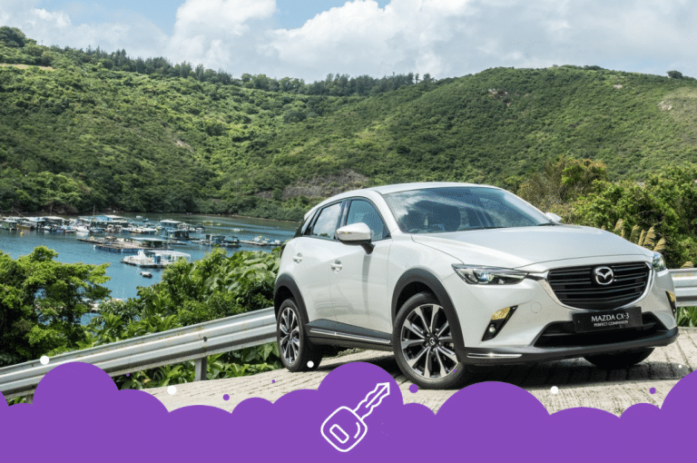 a car parked on a road near a body of water