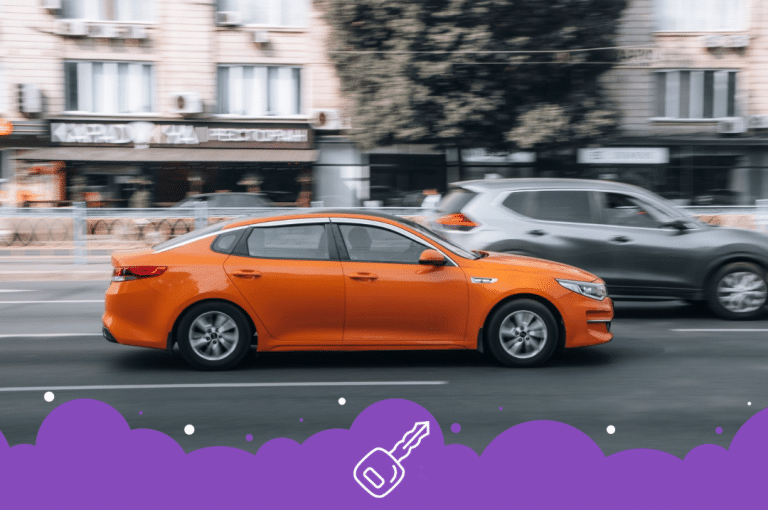 Orange Kia optima driving on the road