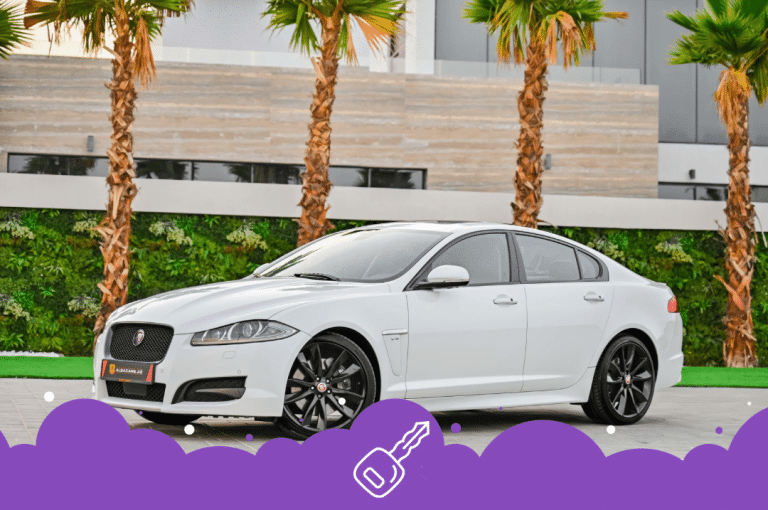 White jaguar xf infront of palm trees