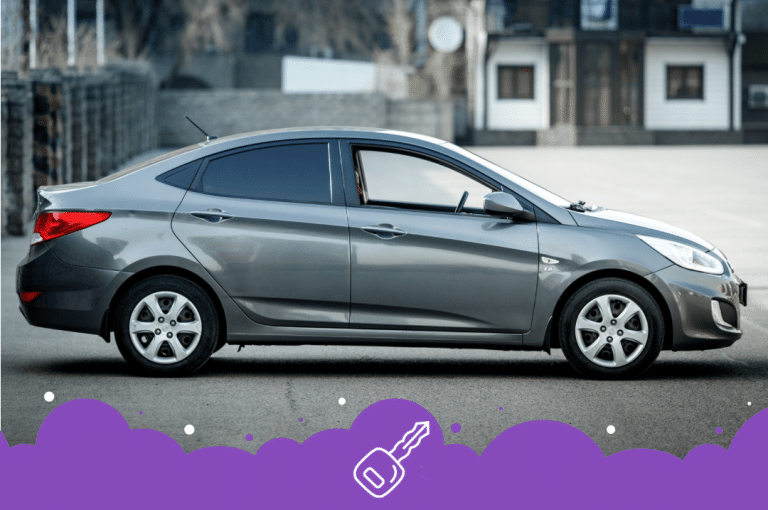 Side angle of a gray Hyundai accent on a road