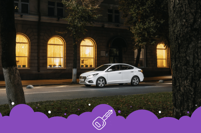 White Hyundai accent parked on side of the road