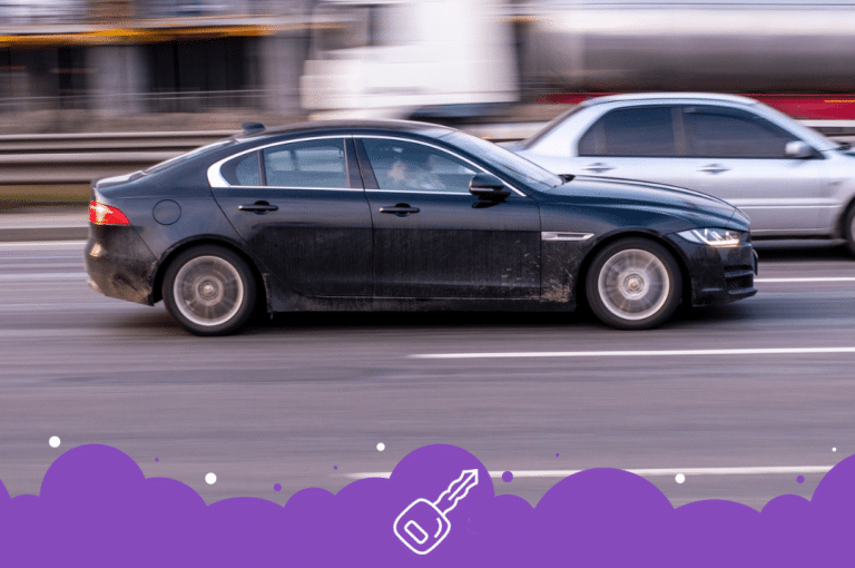 Black jaguar xe driving on the road