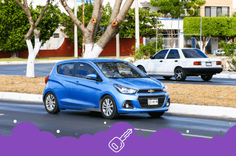 Blue Chevy spark driving on the road