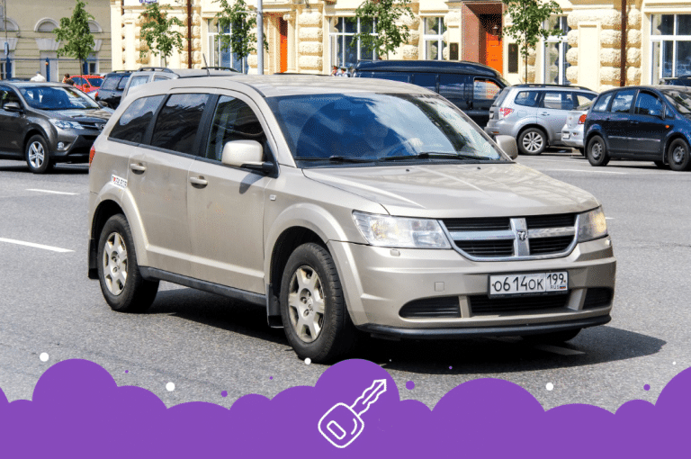 Gold dodge journey driving on the road
