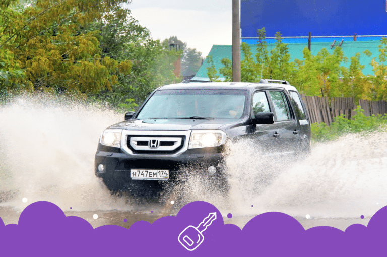 Black Honda pilot going through puddle
