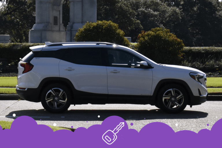 White gmc terrain side shot park in background