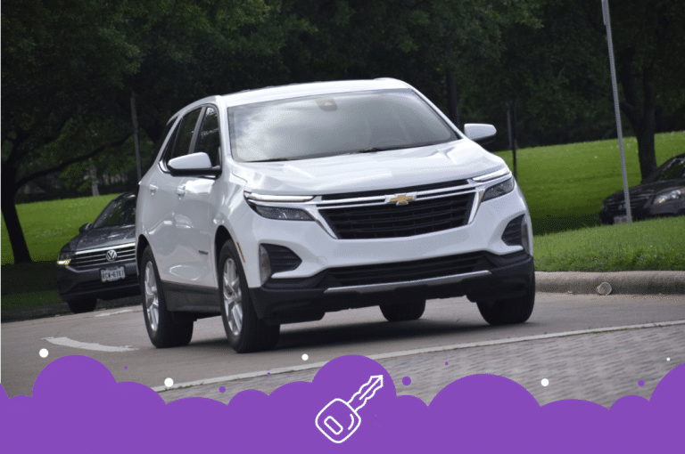 White Chevy equinox driving down the road