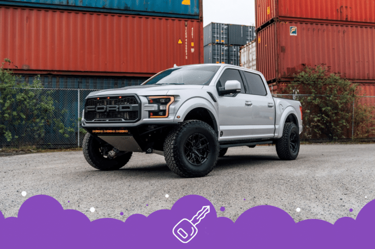 Silver ford raptor infront of shipping containers