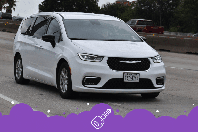 White Chrysler Pacifica driving on road