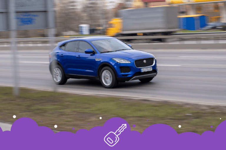 Blue jaguar e pace driving down the road