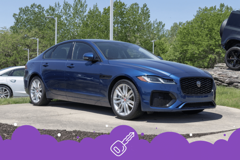 Blue jaguar xf parked in the dealership lot