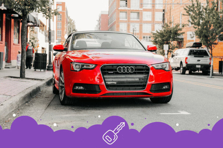 Red Audi car parked on side of road