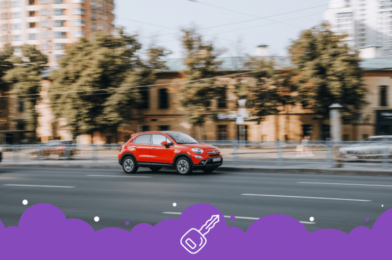 Red fiat 500x driving on road