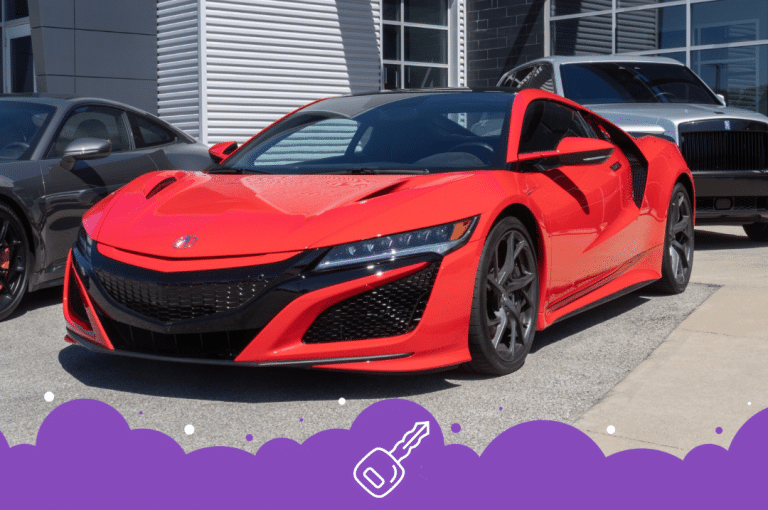 Orange acura nsx parked infront of dealer