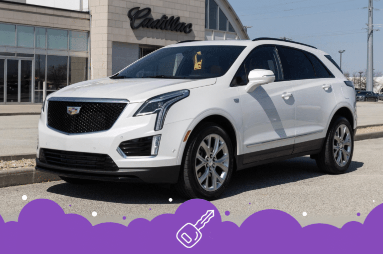 White Cadillac xt5 parked infront of dealer