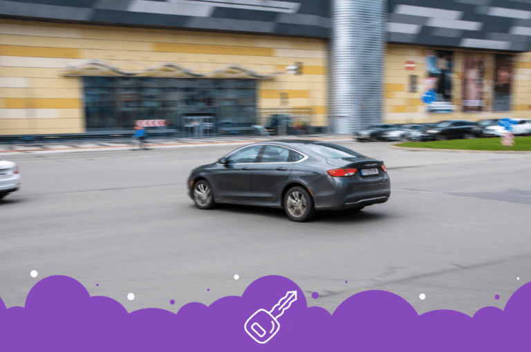 Gray Chrysler 200 turning in parking lot