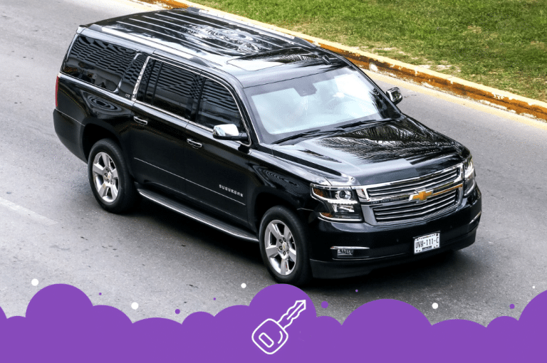 Ariel shot of a black chev suburban driving on road