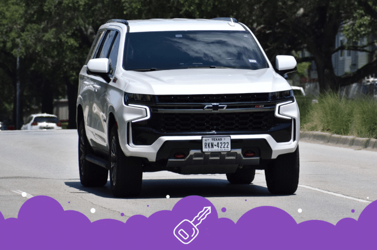 Front shot of white Chevy Tahoe driving on road