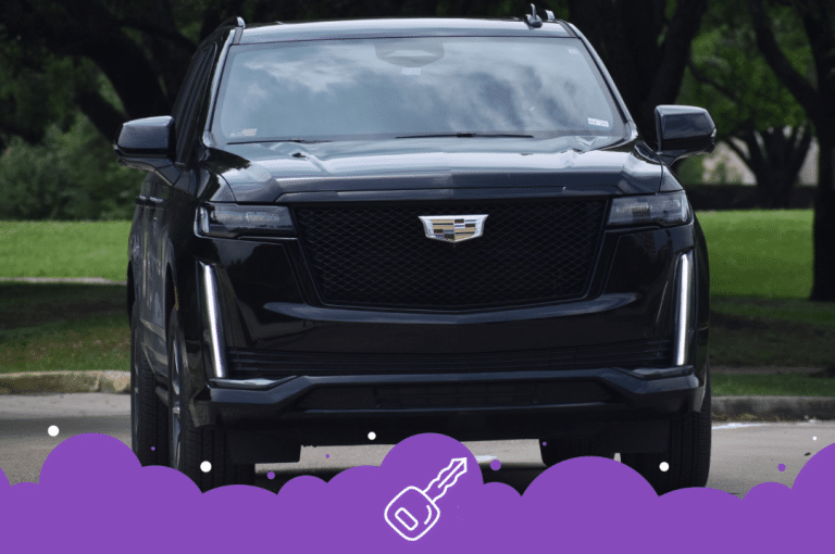 Front shot of black Escalade parked infront of a park