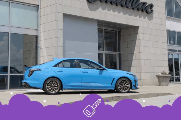 Blue caddy ct4 infront of dealership