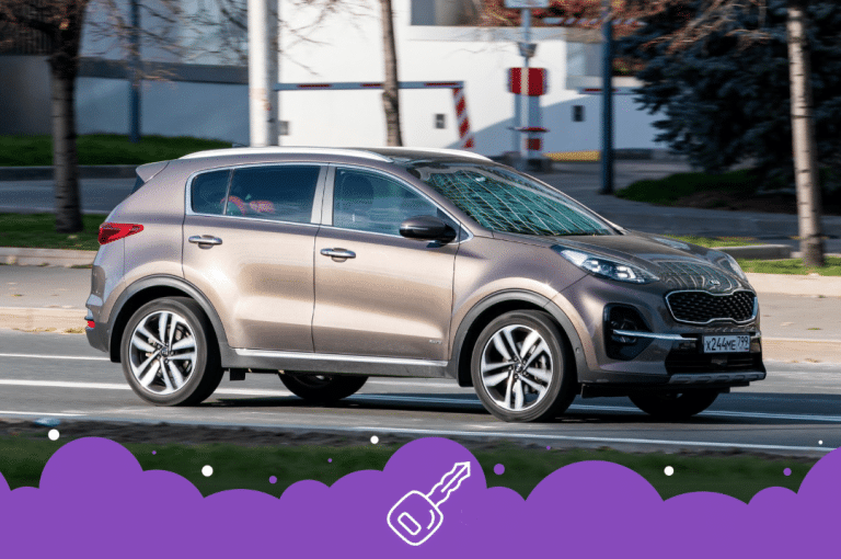 Brown Kia suv driving on road