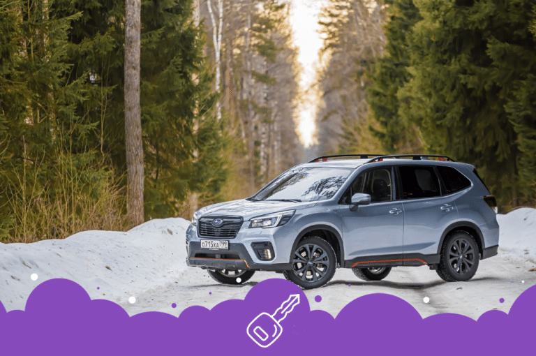 Silver Subaru forester in snow parked