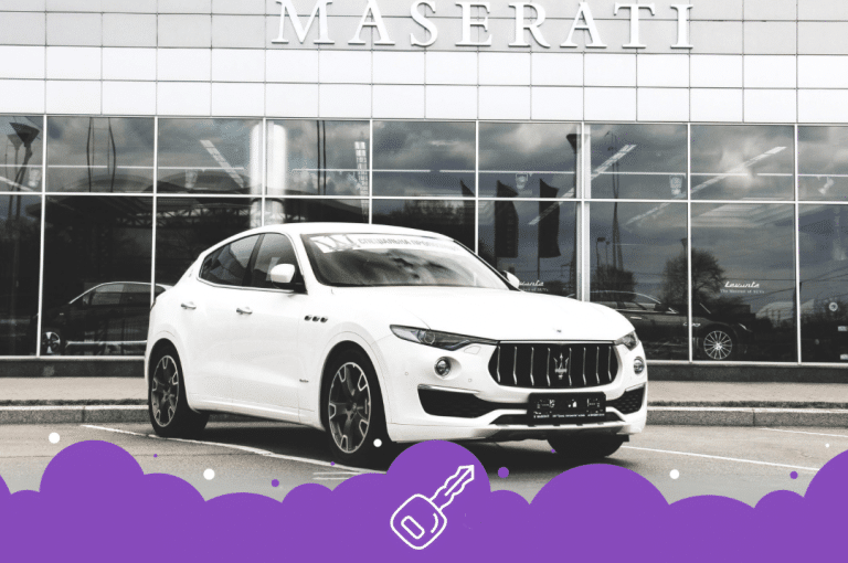 White Maserati suv infront of dealership