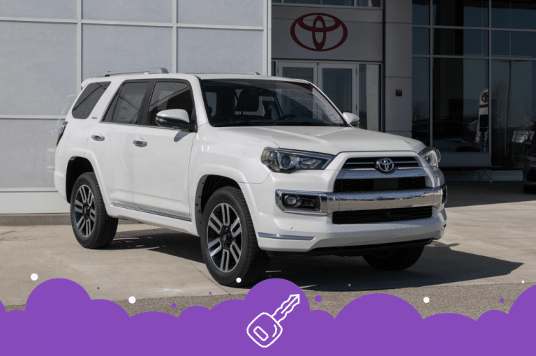 White Toyota 4 runner parked infront of dealer