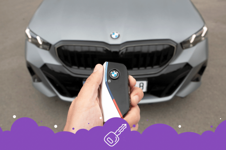 Grey bmw with person holding key