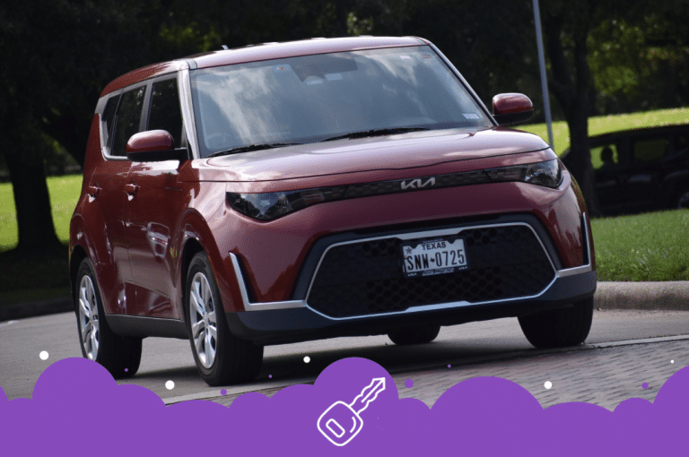 Maroon Kia soul driving