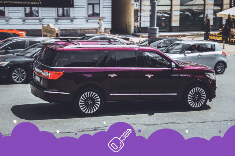 Maroon Lincoln Navigator driving