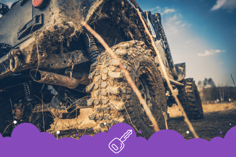 Close up of black dirty Jeep wrangler off roading