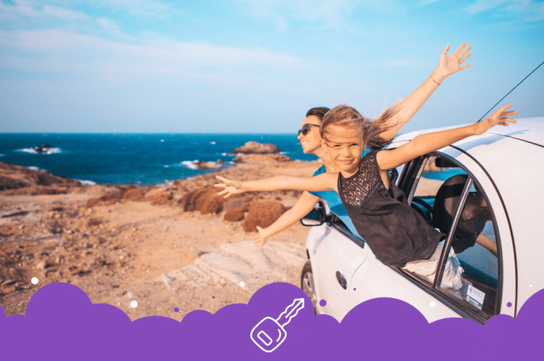 Mom and daughter sticking out of the window enjoying beach ocean views
