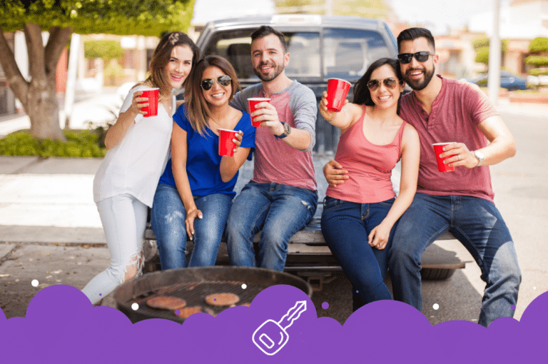 Friends sitting on back of truck with bbq