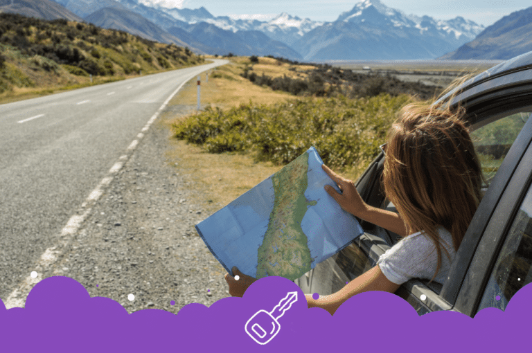 Car pulled over on Side of road by the mountains looking at a map out the window