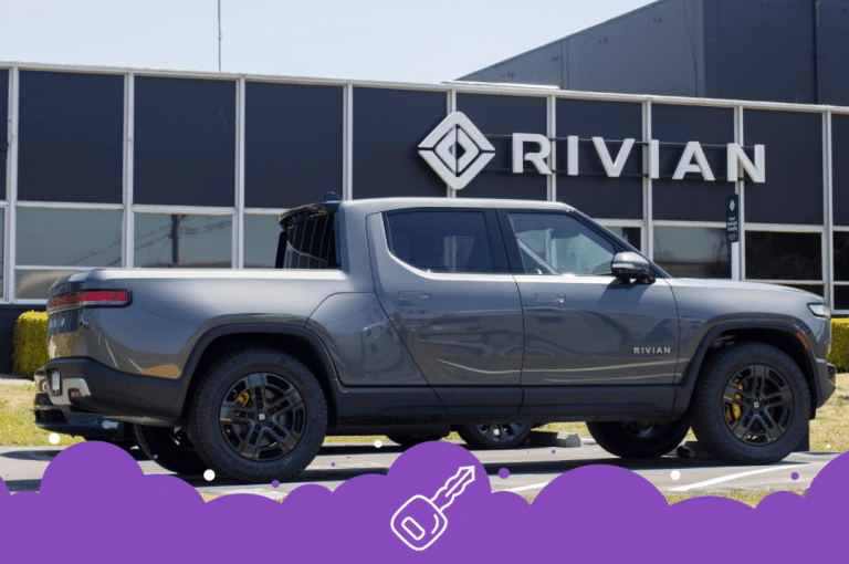 Grey rivian pick up truck parked outside of dealership