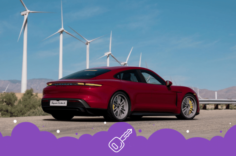 Red Porsche taycan with windmills in the back