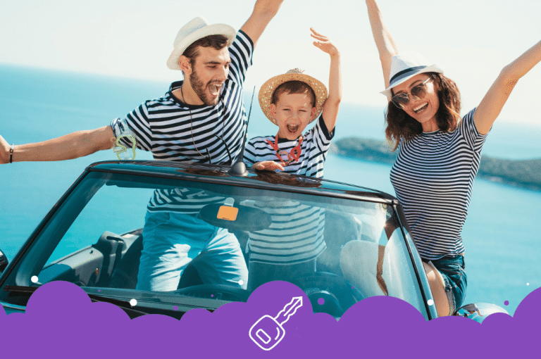 Family of 3 standing up in convertible with arms up